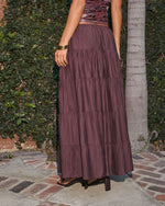 Mauve tiered maxi skirt with ruched velvet top, gold bangles, worn with black heeled sandals on stone patio