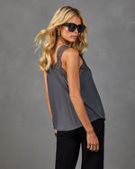 Charcoal gray lace-trim satin cami top on blonde model wearing black sunglasses and pants, side view