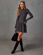 Charcoal gray long sleeve drop waist mini dress with flared cuffs, styled with black suede knee-high boots and a black tote