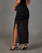 Black sheer plaid flocked maxi skirt with high side slit, styled with black ankle-strap high heel sandals and gold bangle
