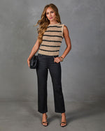 Woman wearing tan black striped crochet knit sleeveless top with black coated straight-leg jeans and strappy heels
