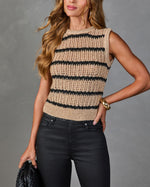 Beige black striped open-knit crochet sweater vest styled with high-waist coated black jeans and gold accessories