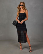 Black plaid mesh midi slip dress with side slit, styled with black heels, quilted chain handbag and gold cuff bracelet