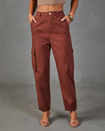 Women's rust brown cargo jogger pants with side pockets, elastic waist and cuffs, styled with heels and crop top