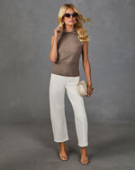 Woman wearing taupe sleeveless knit polo top, white cropped wide-leg jeans, nude strappy heels, cream crossbody bag, gold bangles, oversized sunglasses