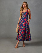 Navy blue floral midi dress with red roses print, square neckline, sleeveless fit-and-flare silhouette, styled with strappy heels