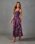 Navy floral midi dress with red roses, square neckline, A-line silhouette, worn with strappy heeled sandals