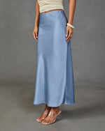 Dusty blue satin maxi slip skirt with A-line silhouette, styled with cream ruched top and clear block heel mules