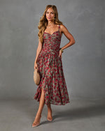 Floral midi dress in sage green and red roses, ruched bodice, spaghetti straps, asymmetric hem, styled with gold jewelry