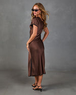 Brown satin midi dress with black trim, short sleeves, and side slit, styled with black kitten heel sandals and sunglasses