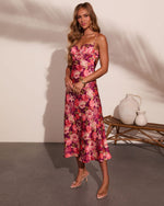 Floral midi dress in purple and pink with lace bust detail, spaghetti straps, and A-line skirt on model wearing clear heels