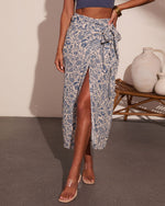 Blue floral paisley wrap midi skirt with front slit, tie waist, paired with clear heeled sandals and blue crop top