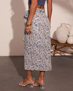 Blue floral print midi wrap skirt in cream, side tie detail, paired with blue crop top and clear block heel sandals