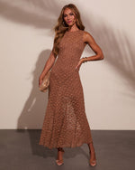 Brown lace midi dress with floral pattern, sleeveless design, flared skirt, styled with nude heels and gold accessories