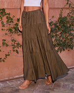 Olive green tiered maxi skirt with drawstring waist, paired with white crop top and tan sandals, boho style