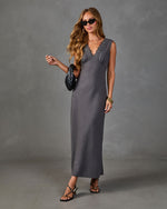 Charcoal gray satin slip maxi dress with lace V-neckline, styled with black strappy heels and woven clutch