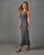 Charcoal gray satin maxi slip dress with lace V-neckline, worn with strappy black heeled sandals and gold jewelry
